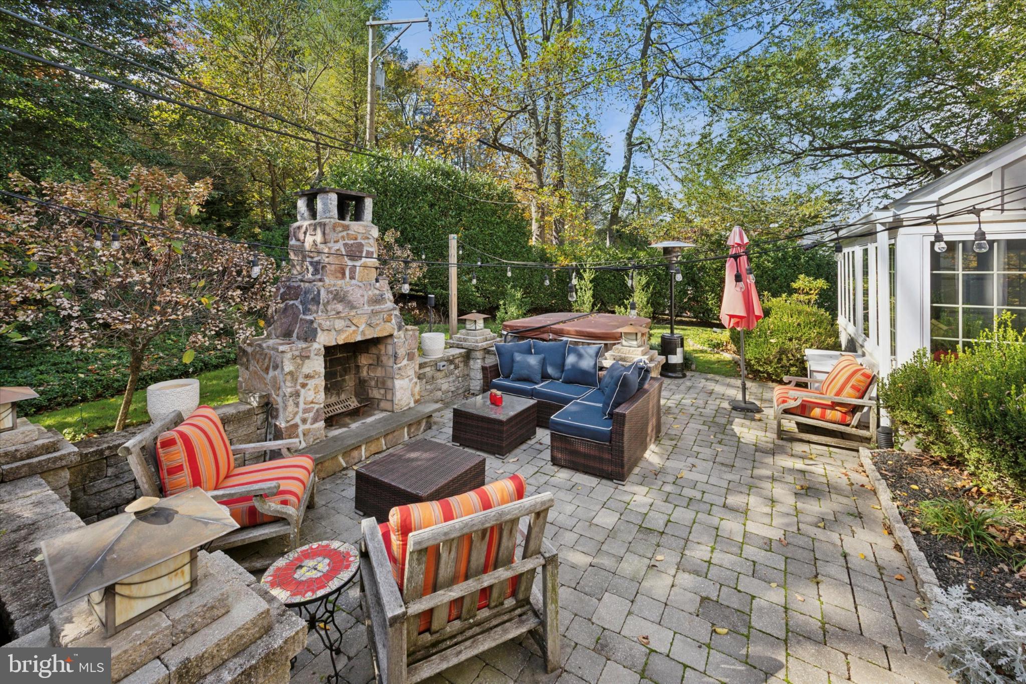 1532 Waverly Road Gladwyne, PA 19035 - Photo 36 of 40 a backyard of a house with barbeque oven table and chairs