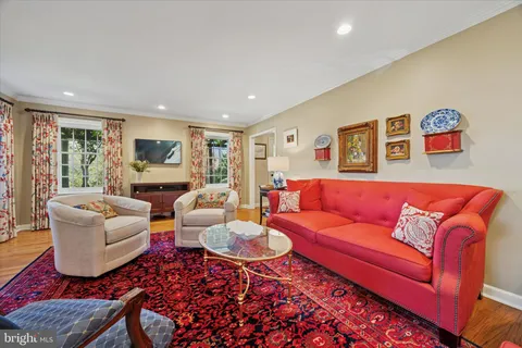 a living room with furniture fireplace and a large window