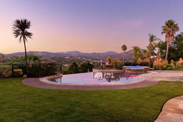 a view of a house with backyard and sitting area