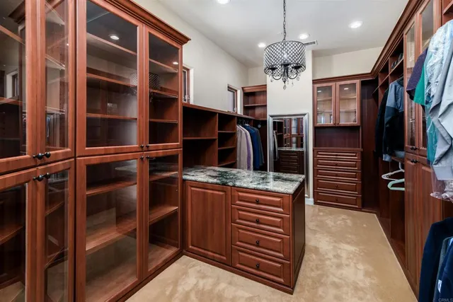 a view of a house with a yard and palm trees