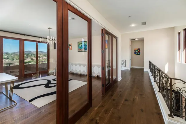 a kitchen with stainless steel appliances granite countertop a refrigerator a stove a sink a dining table and chairs