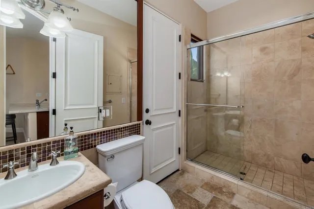 a patio with table and chairs and a garden