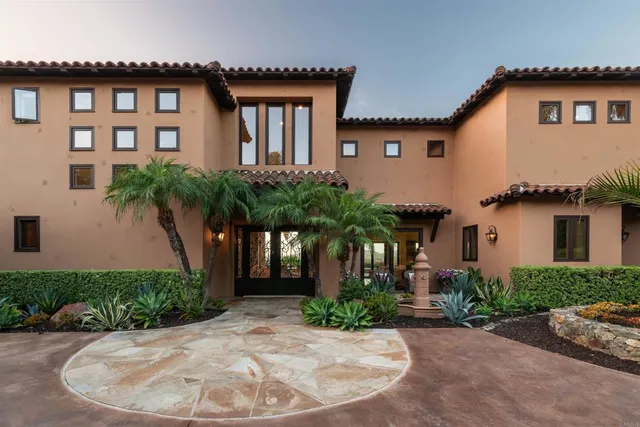 a view of a dining room with furniture a rug and wooden floor