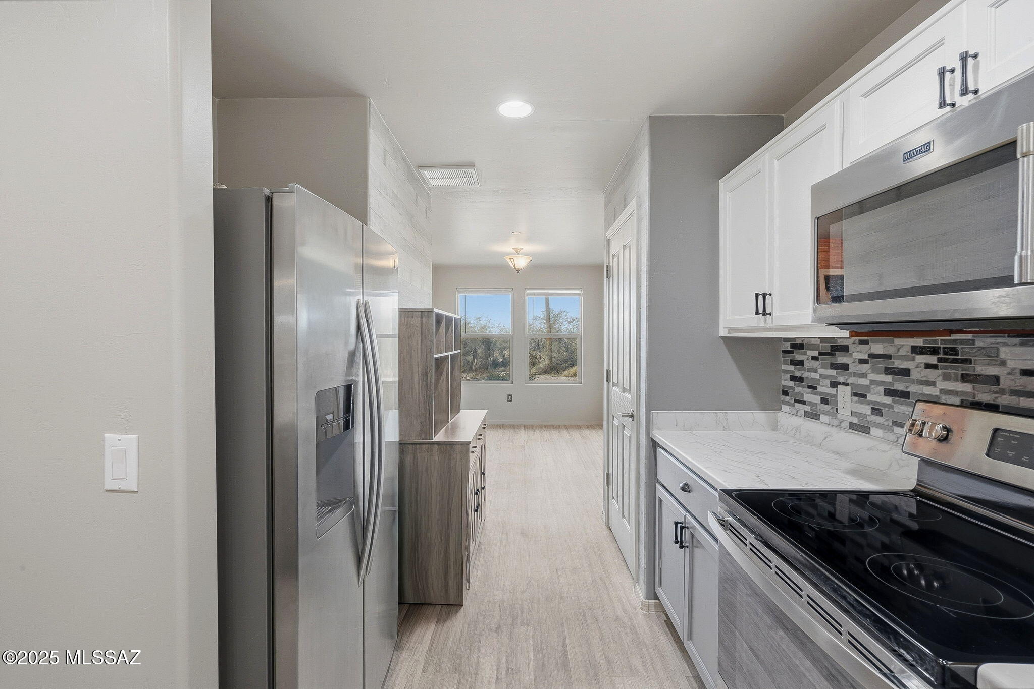 1458 North Wentworth Road Vail, AZ 85641 - Photo 28 of 44 a kitchen with stainless steel appliances granite countertop a refrigerator and a stove top oven