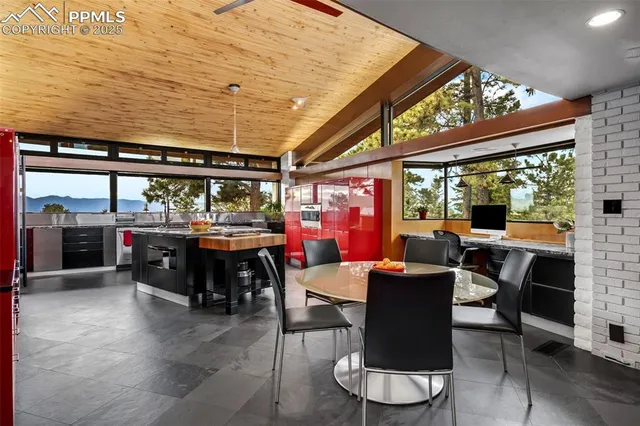 a dining room with furniture and a large window