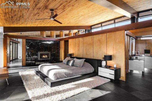 a bedroom with a large bed and a large window with outer view