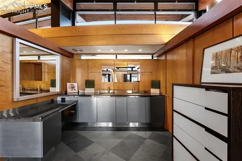 a kitchen with stainless steel appliances kitchen island granite countertop a sink and cabinets