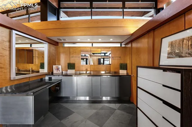 a kitchen with stainless steel appliances kitchen island granite countertop a sink and cabinets