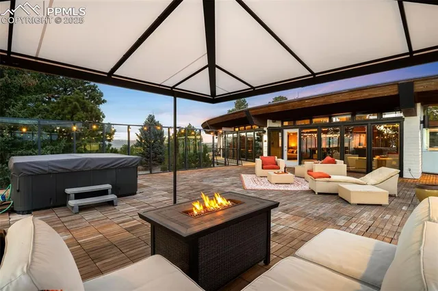 a view of a patio with a dining table and chairs