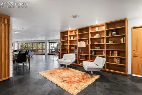 a living room with furniture rug and table