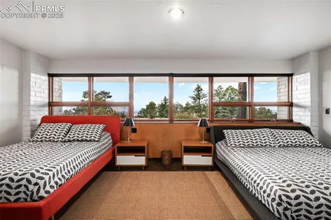 a bedroom with a bed and a large window