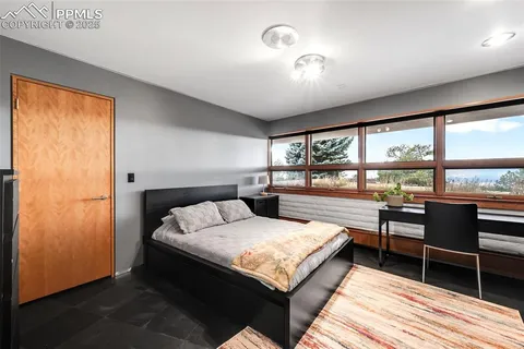 a bedroom with a bed and wooden floor