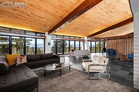 a outdoor living space with furniture and a ceiling fan