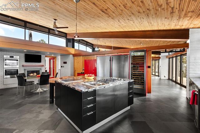 a kitchen with stainless steel appliances granite countertop a stove and a refrigerator