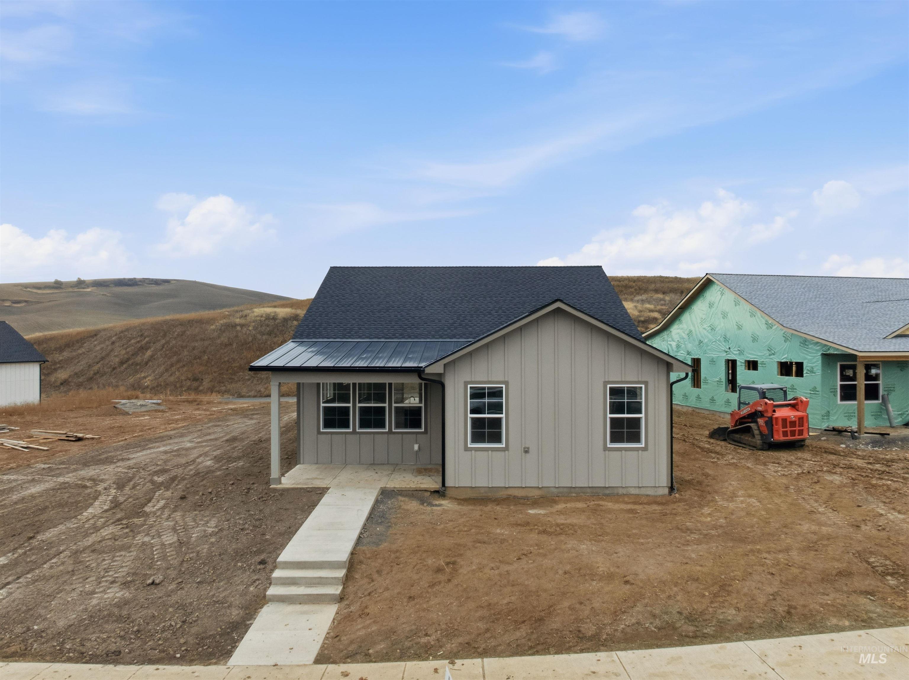 995 Edington Avenue Moscow, ID 83843 - Photo 1 of 1 View of front of property with board and batten siding, roof with shingles, and covered porch