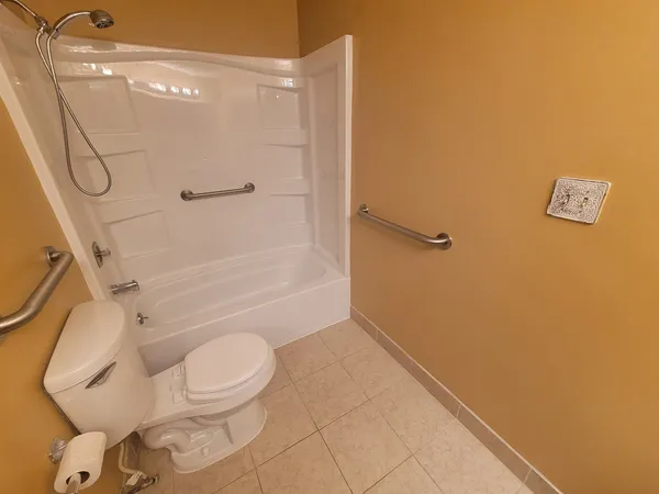 a bathroom with a toilet and shower