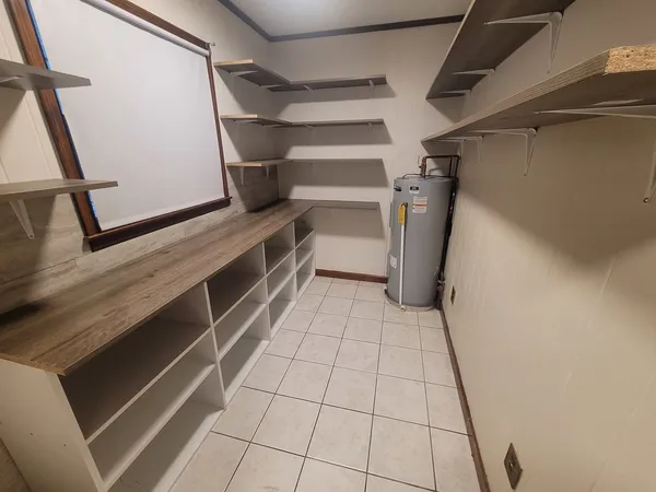 a view of walk in closet with empty racks