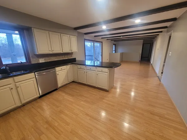 a kitchen with granite countertop a sink and cabinets
