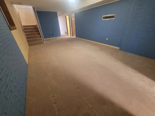 a view of an empty room with stairs