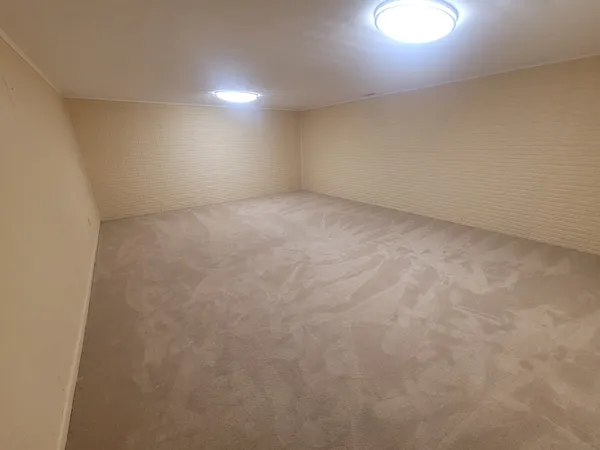 an empty room with a empty space and window