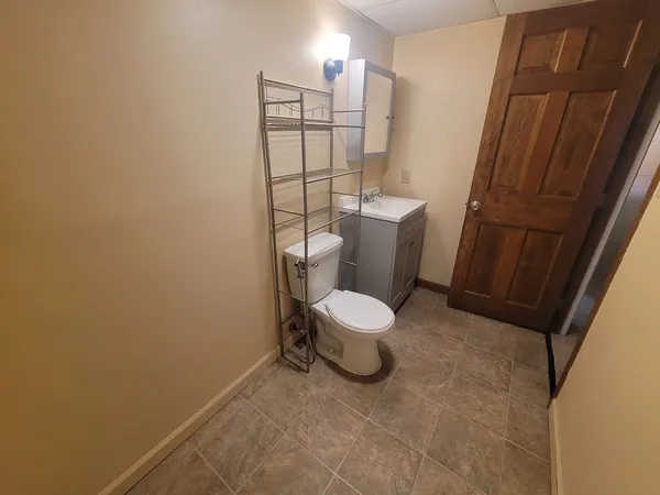 a white toilet sitting next to a bathroom sink