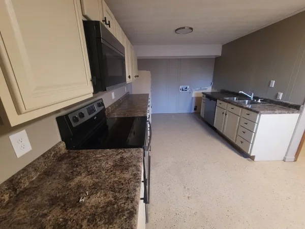 a kitchen with a stove and a microwave
