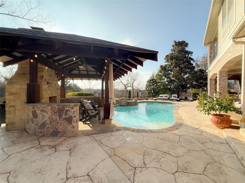 1919 Kings Pass Heath, TX 75032 - Photo 37 of 38 Combined pool / hot tub with a patio and a fenced backyard
