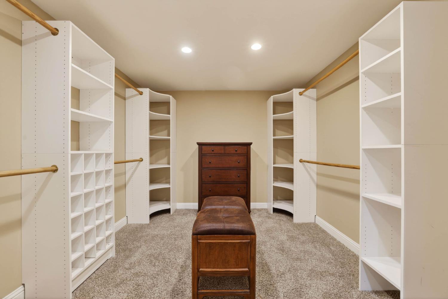 7021 Horseshoe Bar Road Loomis, CA 95650 - Photo 20 of 77 Spacious walk-in primary suite closet with custom built-in shelving, radiant heated floors, and ample hanging space.