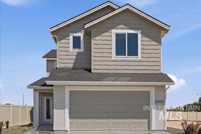 3405 Elliptical Lane Caldwell, ID 83607 - Photo 1 of 17 Two-story residence featuring a two-car garage, gray horizontal siding, and textured shake siding accents