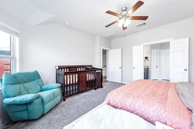 a spacious bedroom with a bed and a couch