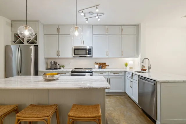 a kitchen with a sink a stove a refrigerator and cabinets