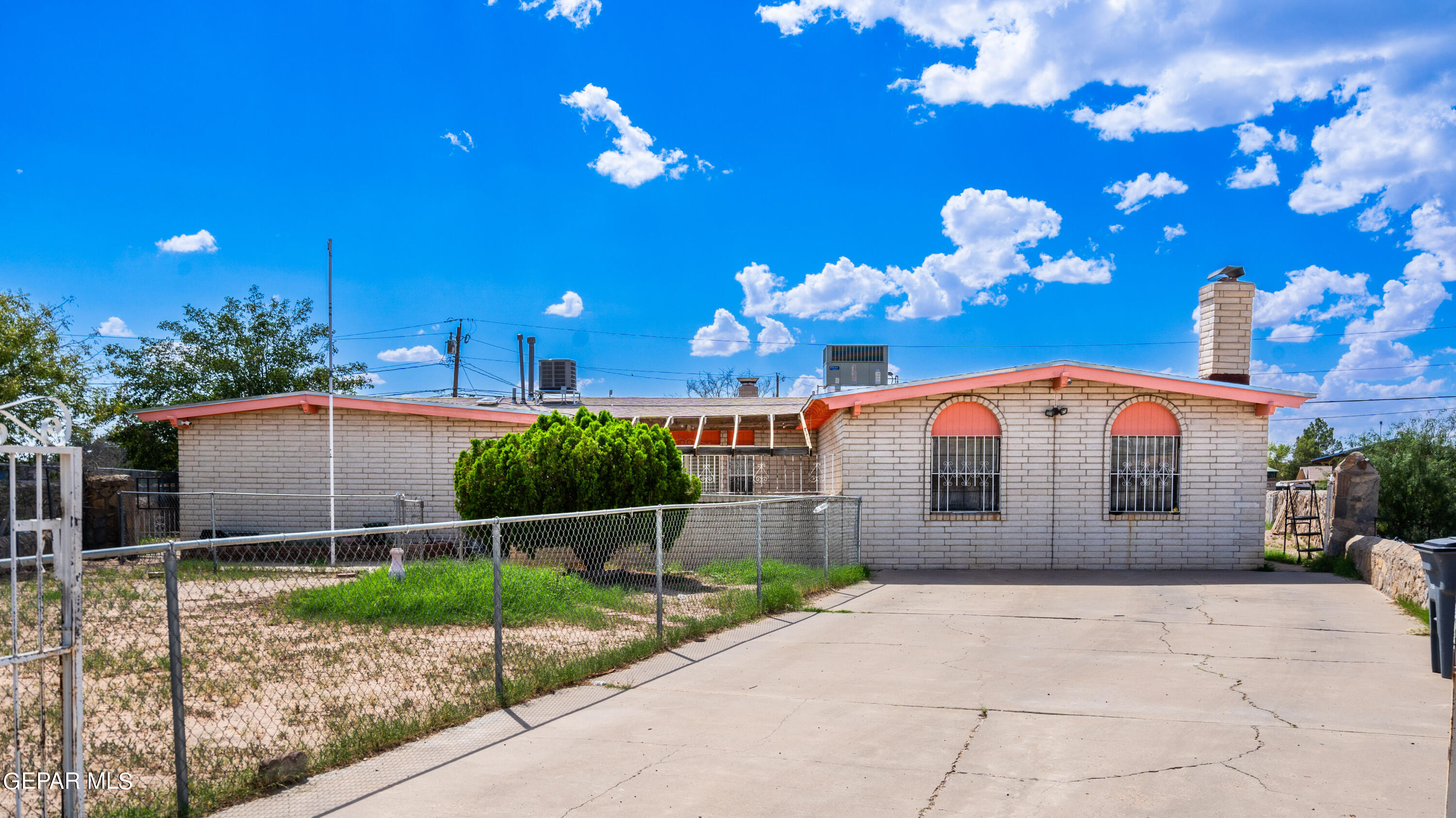 7828 Caliche Drive El Paso, TX 79915 - Photo 1 of 34 a front view of a house with a garden