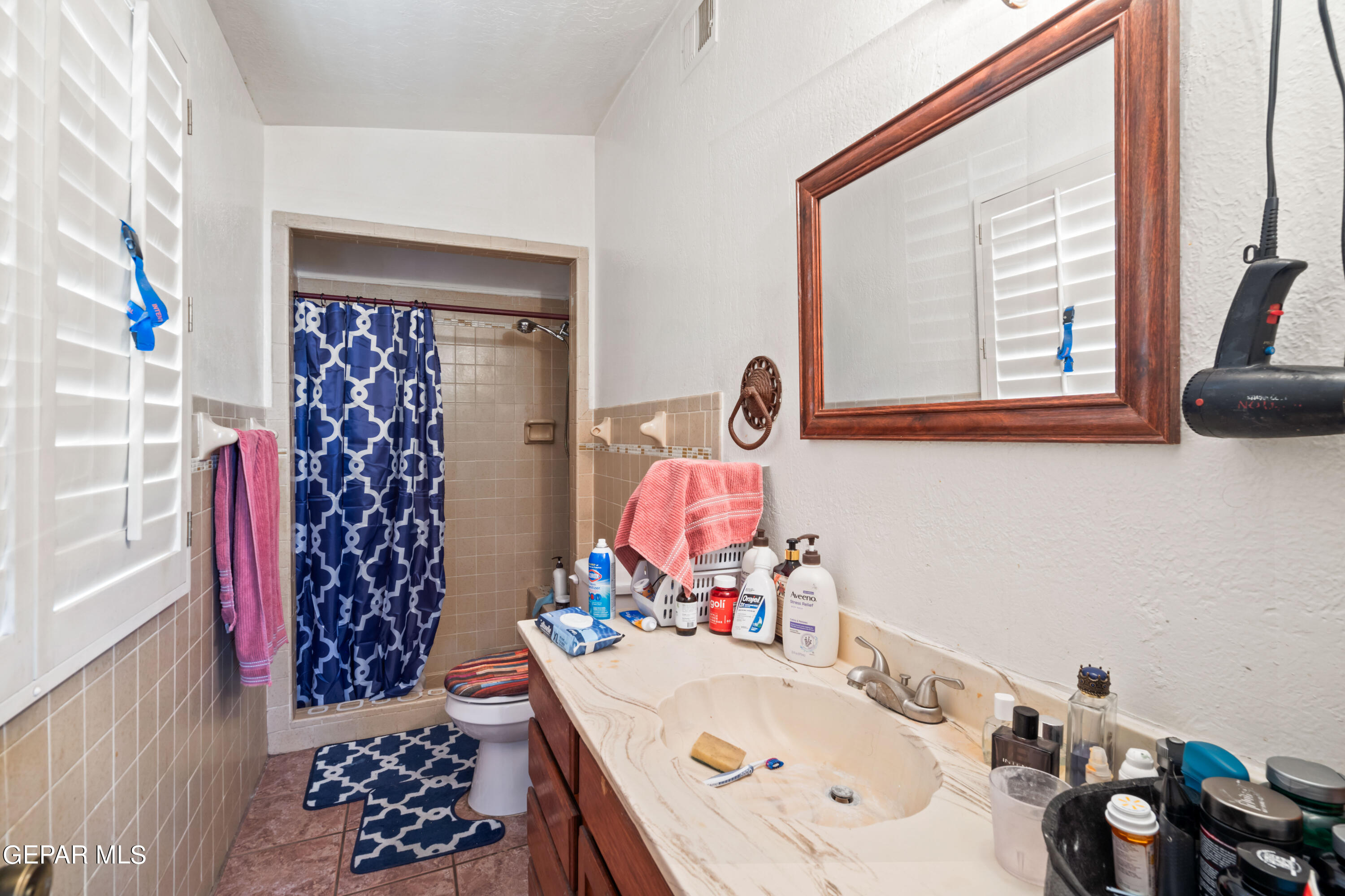 7828 Caliche Drive El Paso, TX 79915 - Photo 19 of 34 a bathroom with a sink mirror and vanity