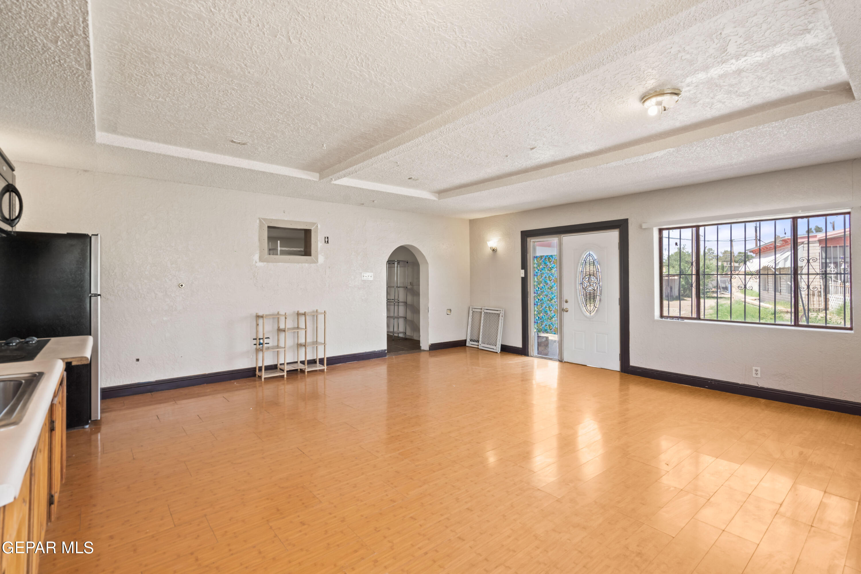 7828 Caliche Drive El Paso, TX 79915 - Photo 25 of 34 a view of an empty room with a window and wooden floor