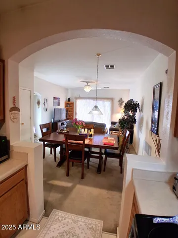 a living room with furniture a rug and a dining table