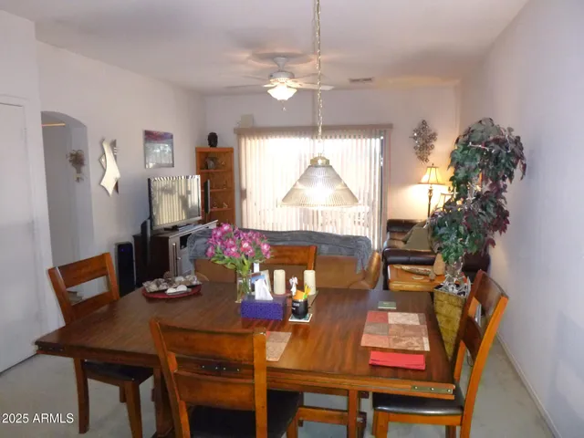a view of a dining room with furniture and chandelier