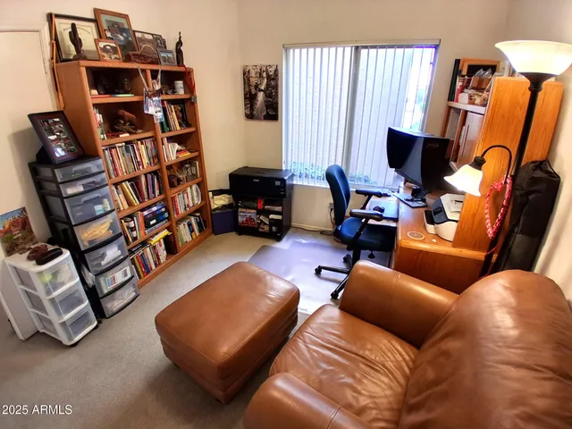 a reading room with furniture and a book shelf