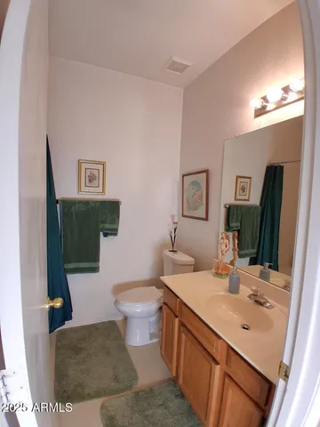 a bathroom with a sink a toilet and mirror
