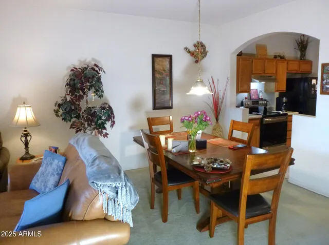 a dining room with furniture and a chandelier