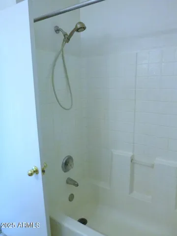 a bathroom with a bath tub with a shower