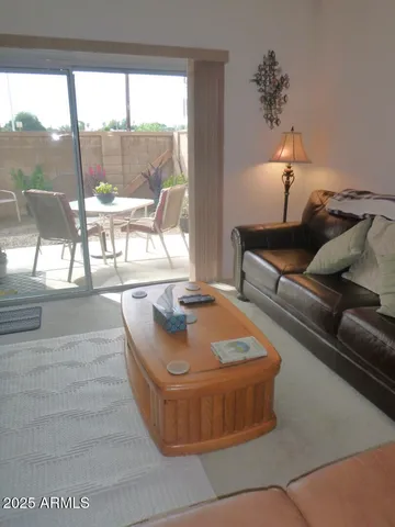 a living room with a couch and a floor to ceiling window