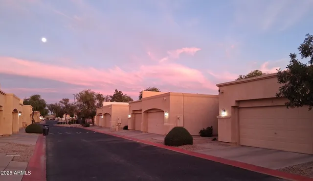 a view of a street in front of a house