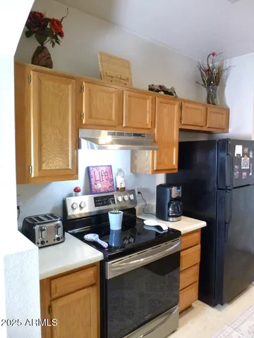 a kitchen with a stove and a refrigerator