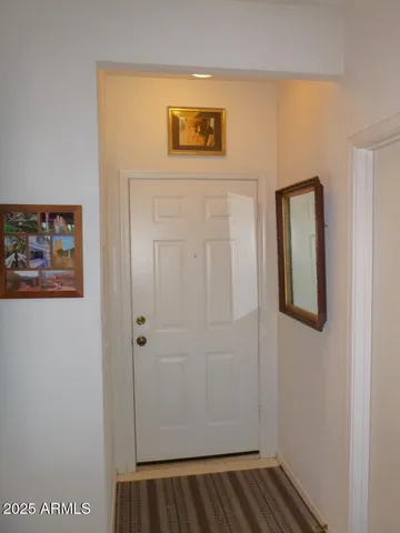 a view of a hallway with paintings on the wall