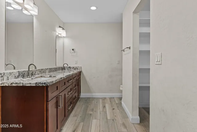 an empty room with fireplace and fan