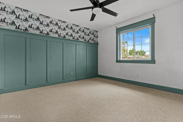 a bedroom with a large bed and a window