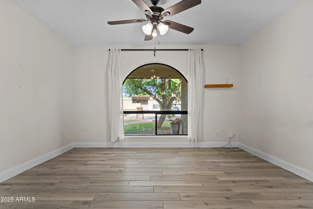 a living room with furniture a rug and white walls