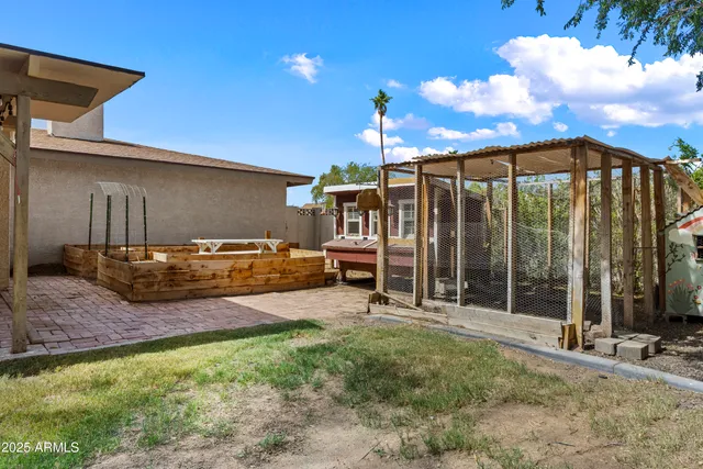 a view of a balcony with chairs and a potted plant