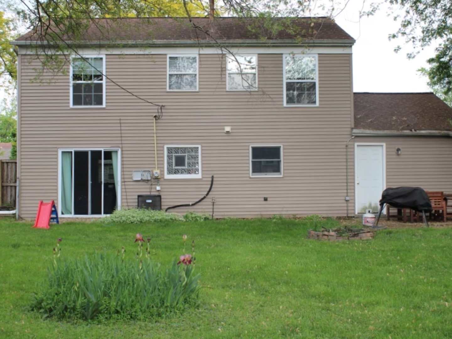 552 Spruce Road Bolingbrook, IL 60440 - Photo 15 of 18 a view of a house with a yard and a tree