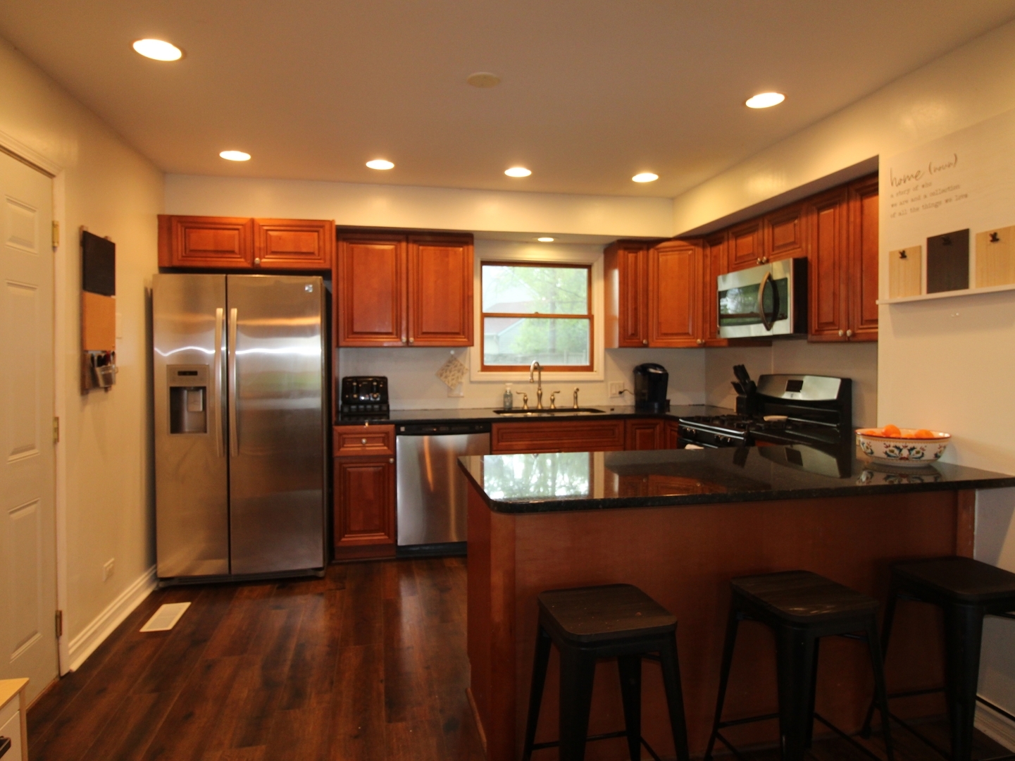 552 Spruce Road Bolingbrook, IL 60440 - Photo 3 of 18 a kitchen with granite countertop a refrigerator a sink a stove a dining table and chairs